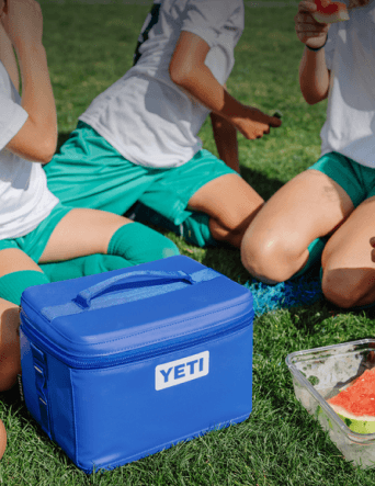 Image on a blue Yeti cooler surrounded by relaxing soccer players