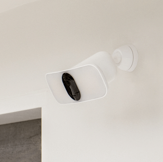 Arlo floodlight mounted on top of a doorway