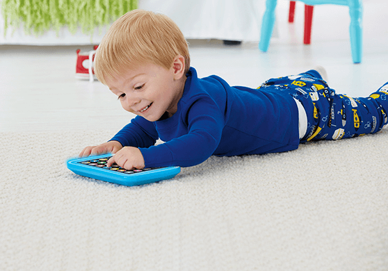 Boy Playing with Tablet on Floor