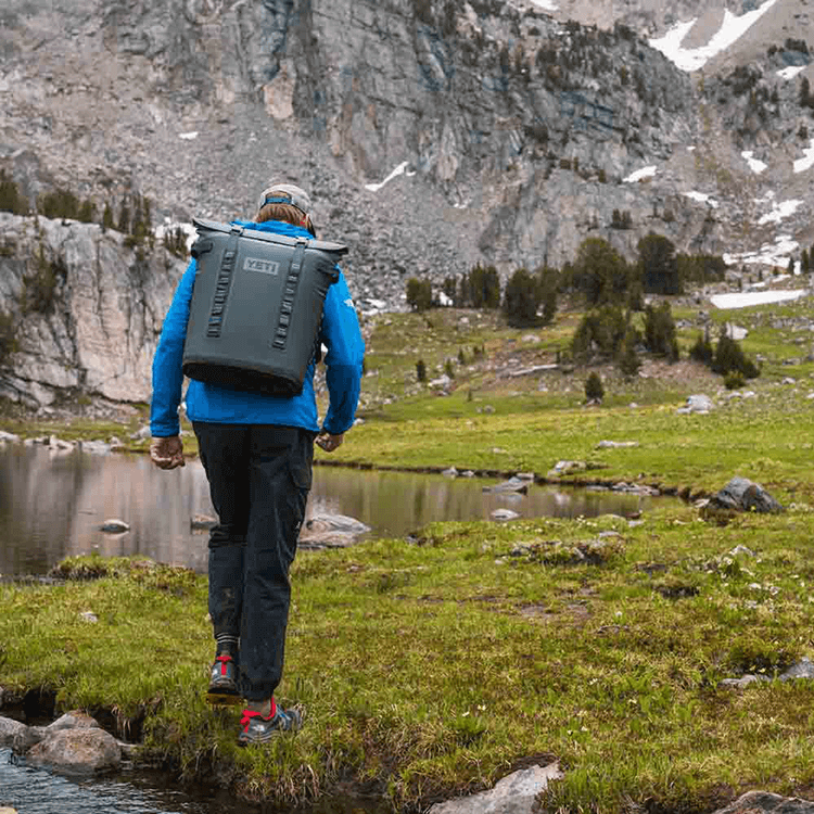 Man hiking with Yeti soft cooler backpack